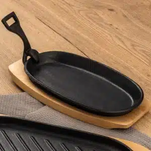 Cast iron oval sizzler plate with wooden base and detachable handle - 24cm life style image